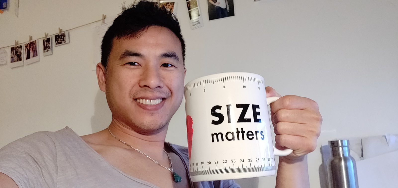 Hoi grinning, holding a giant mug